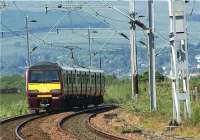 320301 heads west approaching Ardmore East LC with a service to Helensburgh Central on 1 June 2009.<br><br>[John McIntyre 01/06/2009]