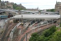 Sunday morning view over the east end of Waverley on 7 June 2009.  An EWS class 90 sleeper locomotive and a pair of stabled North Berwick units occupy the bays, while the empty stock for the 0850 Edinburgh - Plymouth CrossCountry service is running into platform 7.<br>
<br><br>[John Furnevel 07/06/2009]