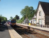 Easterly view towards Carnforth at Silverdale as 185102 calls on its way to Manchester Airport. The <I>Silverdale Shuttle</I>, a rural bus service, connects the village and surrounding area with the trains here and is proving popular. The station house is now a private residence. <br><br>[Mark Bartlett 30/05/2009]