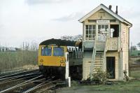 Despite the token catcher at the foot of the signal box steps, the signalman at Westerfield Junction prefers to engage in some rather dangerous gymnastics as an Ipswich bound DMU leaves the Felixstowe branch in November 1978.  With the high volume of freightliner traffic also entering and leaving the branch at that time, continually running up and down the steps would have been particularly punishing.<br><br>[Mark Dufton 25/11/1978]