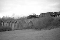 An Ivatt class 2MT propels the local pickup freight from Langholm back over Tarras Viaduct towards Riddings Junction c 1962. Having run direct to Langholm from Carlisle, this propelling manoeuvre avoided the need to run round at both Langholm and Riddings Junction prior to heading north to Newcastleton. After returning from Newcastleton to Carlisle the train will have crossed the border no less than 8 times. [see image 23012]<br><br>[Robin Barbour Collection (Courtesy Bruce McCartney) //1962]