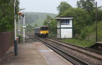 150149 slows as it passes Chapel-en-le-Frith SB and approaches the station on a Buxton to Manchester Piccadilly service on 13 May 2009. This is the former L&NW route to Buxton, the lower level Midland route crosses from left to right via a tunnel below the rear of the DMU.<br><br>[John McIntyre 13/05/2009]