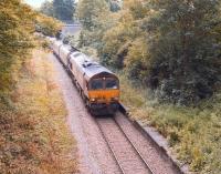 EWS 66057 runs west through the overgrown platforms of the long closed Ashton Gate Station on the Portbury branch with coal empties in May 2009.<br>
<br><br>[Peter Todd 28/05/2009]