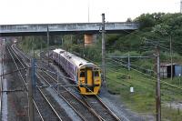 With the closure of the slow lines between Preston and Farington Junction for track renewals on the evening of 13 Jun 2009, services between Blackpool North and York could not access the East Lancashire lines at Farington Curve Junction. These services were diverted via Farington Junction (where a reversal was required) and Lostock Hall Junction. At 2131 hrs 158752 is seen bound for York leaving the WCML at Farington Junction, having already reversed. A Birmingham bound Virgin Voyager is held at the signal on the Up Fast line in the left background. The red earthing straps can be seen on the OHLE for the Slow lines on the left of the picture.<br><br>[John McIntyre 13/06/2009]