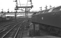 Looking south from the end of the platform at Aberdeen station on 20 February 1977 as 47525 waits to depart and 08515 shunts wagons into Guild Street yard. Beyond the 47 a group of PW staff are working on a diamond crossing.<br><br>[John McIntyre 20/02/1977]