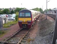 Scene at Airdrie on 16 June looking west towards the station with 320 303 standing in the siding. A quiet period of the day, with the only sign of activity the gentleman on the right striding purposefully along the platform towards the camera... [see image 21892] <br>
<br><br>[John Steven 16/06/2009]