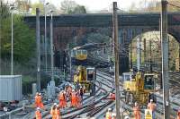 The entire replacement of the switches and crossings at Farington Curve Jct just south of Preston took place over the Easter weekend of 2009. This view over the worksite is looking north with the East Lancs and Ormskirk lines in the left foreground and WCML slow and fast lines to the right. The Freightliner Cl 66 is sat waiting with several flat wagons on the Preston side of Bee Lane bridge.<br><br>[John McIntyre 12/04/2009]