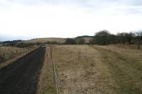 View south on the <i>Waverley line</i> at the site of <i>Stobs Camp Siding</i> which was actually a large yard extending to the access road to Acreknowe farm. From there a tramway crossed the road, and abrubtly dog-legged before eventually reaching <i>Stobs military camp</i>. A spur served the camp bakery and the line ended near one of three <i>YMCA Institute</i> buildings, on the west flank of the camp, roughly level with Winningtonrigg. To the left in this picture can be seen the railway cottages just north of Barnes viaduct. Where the route begins to turn was the location of the large signalbox here. Behind the camera a long headshunt on the up side extended to Colislinn cutting.<br><br>[James Young 06/03/2006]