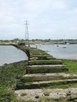 The piers are all that is left of the Hayling Island timber railway bridge. Weight restrictions on the bridge meant the line was worked by tiny A1X class tank engines, nicknamed <I>Terriers</I>, which were originally designed for South London suburban services. The line was closed by BR in 1963.<br><br>[Alistair MacKenzie 17/06/2009]