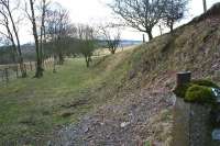 A lamp bracket is still attached to the post marking the end of Stobs Camp sidings headshunt. At this point, the Waverley route is behind a small embankment to the left. View south in March 2006.<br>
<br><br>[James Young 26/03/2006]