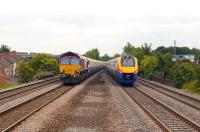 Scene just south of Sileby station on the Midland main line on 22 June 2009. EWS 66067 with a northbound freight passes East Midlands Trains <I>Meridian</I> no 222 021 speeding south towards St Pancras.<br><br>[Peter Todd 22/06/2009]