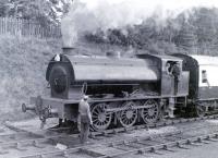 Signalman Neil Clark hands the token to a departing Austerity tank at Boat of Garten in 1979. Photograph taken from Boat South Box.<br><br>[Colin Miller //1979]