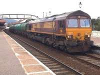 EWS 66107 heading south, with the Lairg empty tanks at the front of the consist, during an early evening crew stop in Aviemore Station on 26 June.<br><br>[David Pesterfield 26/06/2009]