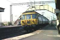 Class 303 unit no 041 arrives at Cardross station with a Bridgeton via Singer service in March 1974. Notice the very low section of platform next to the station building. <br><br>[John McIntyre /03/1974]