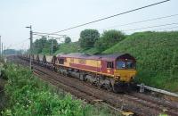 Four wheeled coal hopper wagons are now a rare sight on the WCML but in 2009 train 6S13, Warrington to New Cumnock coal empties, ran MWF passing through Preston at 0725. Here the train is seen at Oubeck loops, powered by EWS Class 66 No. 66060, accelerating away from a signal check. <br><br>[Mark Bartlett 01/07/2009]