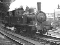 A pair of W Worsdell J72s, nos 69027 and 69005, standing back to back in a scene from the sixties at the west end of Newcastle Central. 113 of these versatile locomotives were eventually built, the first in 1898 and the last in 1951. The 53 year production span is thought to be a record for a class of British steam locomotive.<br><br>[K A Gray //]