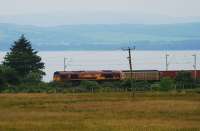Ex-Glen Douglas freight heads east towards Ardmore East Level Crossing on 2 July.<br><br>[Ewan Crawford 02/07/2009]