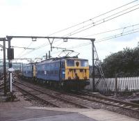 Class EM1s 76030+76021 about to run east through Dinting station on 15 August 1979 with a train of steel flats bound for Sheffield via the Woodhead route.<br><br>[Peter Todd 15/08/1979]