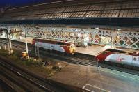 A Pendolino stands at Preston platform 4 on 18 June 2009, having terminated here with the 2030 hrs ex London Euston. Thunderbird 57312 <I>The Hood</I> has appeared at the rear of the set and an attempt has just been made to extend the Pendolino's Dellner coupler. This has failed and the 57 is about to move off empty handed. The photograph was taken from the top deck of  the new multi-storey car park alongside Preston station which had opened a few days earlier. [Note: One explanation for these manoeuvres is that the 57 was intending to haul the Pendolino to Longsight depot via Chorley and Bolton and that the problem with the coupler necessitated the train being rerouted back to Crewe then on to Longsight under the wires.]  <br>
<br><br>[John McIntyre 18/06/2009]