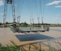 Originally capable of carrying nine motor cars, the Rochefort transporter bridge is now restricted to foot passengers and bicycles. It provides a useful link across the River Charente in summer months and the 140m trip across the river is well worth the 2 Euro return fare. [See image 24426]<br><br>[Mark Bartlett 24/06/2009]