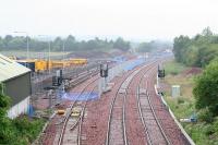 View west from the B792 at Bathgate on 27 June 2009. Fencing to protect the new Bathgate TMD is taking shape with the first of the new sidings associated with the depot on the left.<br><br>[James Young 27/06/2009]