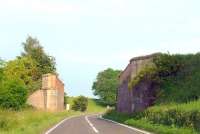 The remaining abutments of the bridge that carried the Newburgh and North Fife Railway across the A913 road between Glenbirnie Junction and Lindores. Opened in 1909 the expected traffic never materialised and passenger services on the line ceased in 1951. The majority of the line between Lindores and St Fort closed completely in 1964 and the final section back to Glenbirnie Junction in 1969. <br>
<br><br>[Brian Forbes 07/07/2009]