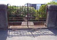 Once the entrance to  Deanside station, the gates that formerly gave access to the steps down to the island platform from alongside the A8 are now fastened together with fishplates, seen here in July 2009. As short-lived passenger stations go Deanside must come near the top of the league, having been opened by the Glasgow and Renfrew District Railway on 1 June 1903, it was closed on 2 January 1905 after a period of 582 days [see image 9092].   <br>
<br><br>[Colin Miller 05/07/2009]