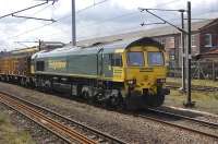 Freightliner 66605 passing through Doncaster on 8 July with the works dominating the background. The train is the Manchester <I>Binliner</I>, from Northenden waste terminal heading for Roxby, Lincolnshire, location of a major landfill on the site of a disused ironstone mine around 4 miles north of Scunthorpe.<br>
<br><br>[Bill Roberton 08/07/2009]