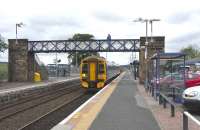 As a service heads off for Inverurie in the background, 158 715 is belled off for Aberdeen from Dyce station on 15 June 2009.<br><br>[David Panton 15/06/2009]