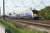 A journey between Blackpool North and Manchester with Northern Rail can produce a widely differing standard of rolling stock. At the bottom of the range you could be privileged to get a Class 142. Getting better it could be a Class 150 or a Class 156 but at the top of the range you could be lucky and travel on one of the two Class 180 5 car sets that Northern have leased. Here looking south towards Leyland we see 180108 on the up slow line on a service to Manchester Victoria on 25 May 2009.<br><br>[John McIntyre 25/05/2009]