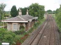 Aynho station, closed in 1964, still stands alongside the Oxford to Banbury line. This is the view north from the overbridge and, in the distance, the flyover at Aynho Junction can be seen where the down Princes Risborough direct line is carried over the bridge to join the line in the foreground. <br><br>[Mark Bartlett 18/06/2009]
