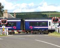 The 1114 Perth - Glasgow scuttles over the crossing at Forteviot on 13 July.<br><br>[Brian Forbes 13/07/2009]