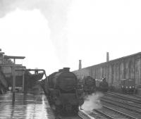 A wet, overcast, miserable, dreich day in Carlisle in 1965 with Kingmoor Black 5 no 44986 at platform 1 with a Chippenham - Glasgow Central military special. To the right of the train Britannia Pacific no 70003 <I>John Bunyan</I> is waiting to take over the 9.10am Liverpool - Glasgow Central/Edinburgh Princes Street train, while on the extreme right of the picture station pilot no 47326 is having a break.<br><br>[K A Gray 31/07/1965]