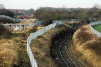 Environs of Warsop Junction; a complicated location. The line to the right is the 1974 British Railways north (Shirebrook East Junction) to east (Warsop Junction) link between the former Lancashire, Derbyshire and East Coast Railway and the Midland Railway's Worksop Branch. This completed a triangle of junctions. The Midland line is in a cutting running from left to right. On the left and running straight on (closed and lifted) is the mainline of the LD&ECR which crossed the Midland. A short portion of this line remains unused but in place connected by a Midland Railway curve to Shirebrook Junction. This portion serves the W.H. Davis Wagon Works (itself a stub of the GNR line to Mansfield) approached by a reversal at the former Langwith Junction. Out of shot far to the left is the still open east to south connection between the Midland and LD&ECR. The view looks west along the LD&ECR (later the Great Central) which formerly continued to west Chesterfield and north to Sheffield.<br><br>[Ewan Crawford 14/01/2005]