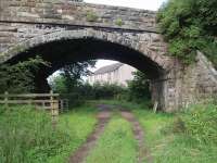 Hornby station closed in 1957, nine years before the line itself. Once the line had closed completely a small housing development was built on the station site, including the trackbed. This view is towards Lancaster. The station platforms were immediately beyond the overbridge. Map Ref SD 586680.   <br><br>[Mark Bartlett 14/07/2009]