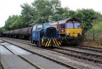 DBS 66078 brings the Lindsey to Preston tar tanks into the exchange sidings at Preston Docks as Ribble Rail Sentinel waits to take over for the final leg of the journey to the refinery on 17 July 2009. On the far left the outgoing tank wagons waiting for the return trip to Lindsey.<br><br>[John McIntyre 17/07/2009]