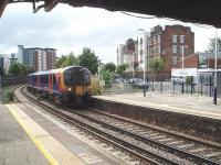 SWT 450018, just out from Portsmouth on its way to London Waterloo, rolls into Fratton leading a twelve coach (3x4 car) set. View towards Portsmouth from the island platform on the down side. <br><br>[Mark Bartlett 18/06/2009]