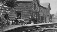 Early view of the station at Barton and Broughton showing the station master and his staff outside the down side buildings. While the station was still open the bay window seen here was removed as it probably made the platform alongside this main line too narrow. The buildings continued in private use long after closure in 1939 and were only demolished in 2013. [See image 23758]. From a Frederick Cooper postcard. <br><br>[Rev Ron Greenall Collection //1905]