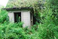 A trackside hut and roadbridge are two reminders of the station at Woodside and Burrelton. The goods yard and much of the station area site is now small housing estate. The station building also remains standing [See image 15879].<br><br>[Ewan Crawford 12/07/2009]