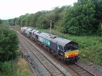 <I>Motive power considerably longer than train</I>. With the DRS Class 20 locos in Eastleigh for assessment the Class 66s are frequently being rostered on flask trains. With only a fraction of the 6600hp available being used 66428 and 66425 hustle the 6K73 Sellafield to Crewe, comprising a single flask wagon, south passing Broad Fall Farm at Scorton on a Monday evening. This train is a useful means of getting locomotives to Crewe too and the previous Monday had two Class 37s in tow in addition to the two 66s. <br><br>[Mark Bartlett 20/07/2009]