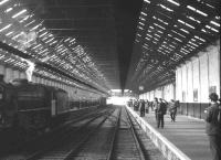 The LCGB <I>Lancastrian</I> railtour in the trainshed of Liverpool Riverside station on 6 April 1968, with Black 5 no 45305 in the process of running round. The 1895 Riverside station was provided by the Mersey Docks and Harbour Board specifically to handle boat trains and became well known in connection with the former LNWR <I>American Specials</I> that ran from London Euston and the numerous troop trains during WW2. The last train to use the station carried soldiers bound for Northern Ireland in 1971. Riverside station has since been demolished. [See image 24724]<br><br>[K A Gray 06/04/1968]