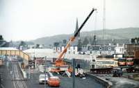 Ongoing rationalisation work at Largs station in 1986 sees the removal of the 100 year old footbridge.<br><br>[Colin Miller //1986]
