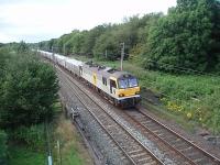 With a much longer load than the preceeding train, [See Image 24693] 92013 <I>Puccini</I> hauls the 6X12 Carlisle to Eastleigh <I>Enterprise</I> service under the footbridge at Broad Fall Farm,  Scorton as the daylight fades. <br><br>[Mark Bartlett 20/07/2009]