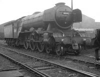 Another of the Gresley A3s to spend her final days at St Margarets was no 60042 <I>Singapore</I>. The Pacific, seen here displaying a 64A shed plate and looking very businesslike, is standing in the rain at Gateshead, near the end, with some of the depot's growing number of diesel locomotives  in the background. 60042 was  withdrawn from St Margarets in July of 1964 and cut up at Arnott Young, Carmyle, three months later.<br>
<br><br>[K A Gray //1964]