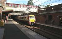 The 0923 Gourock - Glasgow Central emerges from the 1.2 mile Newton Street tunnel into Greenock West station on a bright and sunny Sunday morning in July 2007. Forming part of the 1889 Gourock Extension, the country's longest tunnel runs from here, below Newton Street and beyond, to emerge just east of Fort Matilda station on the western edge of Greenock.<br>
<br><br>[John Furnevel 29/07/2007]