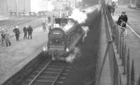 McIntosh 3F no 57550 of 64C Dalry Road shed stands at the CR Leith North station on 3 February 1962 with the <I>Peebles Railtour</I>.  The station, opened as Leith in 1879, became North Leith in 1903, then Leith North in 1952, the name it held when it finally closed in April 1962, some 2 months after the photograph was taken.  All has since been transformed here, with much of the area given over to new roads, housing and retail units and with the large  Ocean Terminal development located off to the left. Note also the view on the right looking east along Lindsay Road, with traffic consisting of a bus, two cars (parked) and a bike! <br>
<br><br>[K A Gray 03/02/1962]