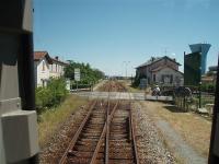 Cognac - a name to conjure with for brandy drinkers but the station is nothing special to look at. This is a DMU driver's eye view of the station approach from the west end and the start of the passing loop. The crossing keeper's cottage on the left is now a private house, as are all the many others on this line. Behind the station is a large container depot with a resident SNCF shunter, or <I>tracteur</I> as they are known in France. No prizes for guessing the principal commodity being shipped out. <br><br>[Mark Bartlett 23/06/2009]