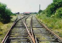 Girvan Goods looking to the buffers in 1989. Girvan (Old) station and loco shed were to the left (track lifted). The line continued to the harbour until the late 1960s. In the 1980s the site was still in use as a goods yard but the state of the viaduct over the Water of Girvan led to its closure not long before this photograph was taken. [Access by kind permission of British Rail.] [See image 24816]<br><br>[Ewan Crawford //1989]