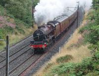 The first of the <I>Fellsman</I> steam excursions from Lancaster departed in poor weather and is seen here heading south at Cleveley Bank Lane Bridge, Forton, behind Jubilee 4-6-0 5690 <I>Leander</I>. All six tours are reported fully booked for the trips to Carlisle via Preston, Blackburn, Hellifield and the S&C and return by the same route.  <br><br>[Mark Bartlett 29/07/2009]