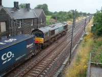 On the roll again after waiting in the goods loop just south of the closed Barton and Broughton station. 66419 accelerates a lengthy Tesco container northwards past the old station building on a very wet Saturday morning. <br><br>[Mark Bartlett 01/08/2009]
